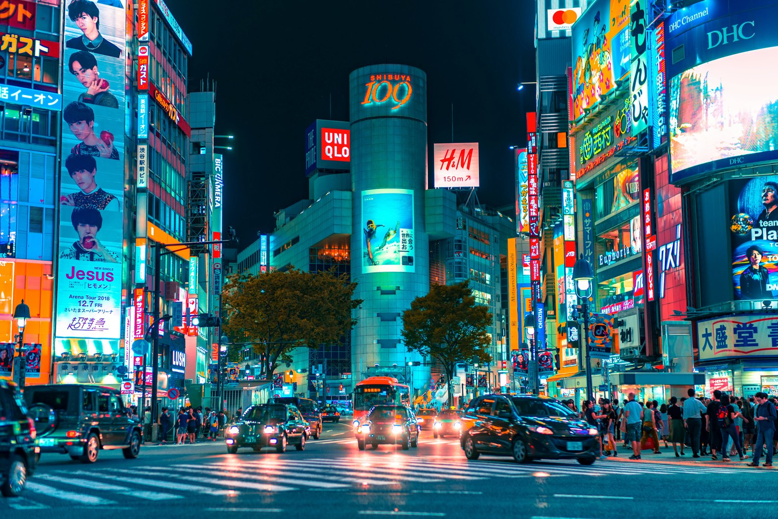 Shibuya at night with illuminated buildings